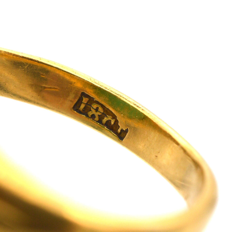 Close-up of the hallmark inside an 18ct gold Art Deco signet ring, showcasing its exquisite craftsmanship.