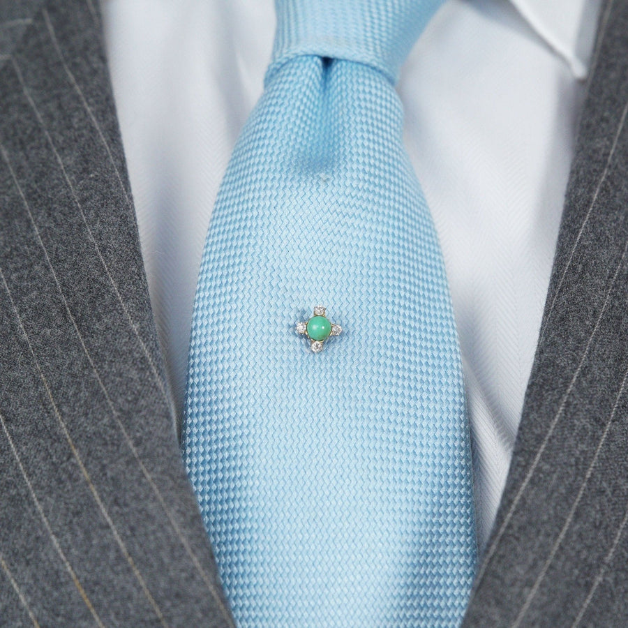 Art Deco 18ct gold tie pin featuring old mine cut diamond and turquoise on a light blue silk tie.