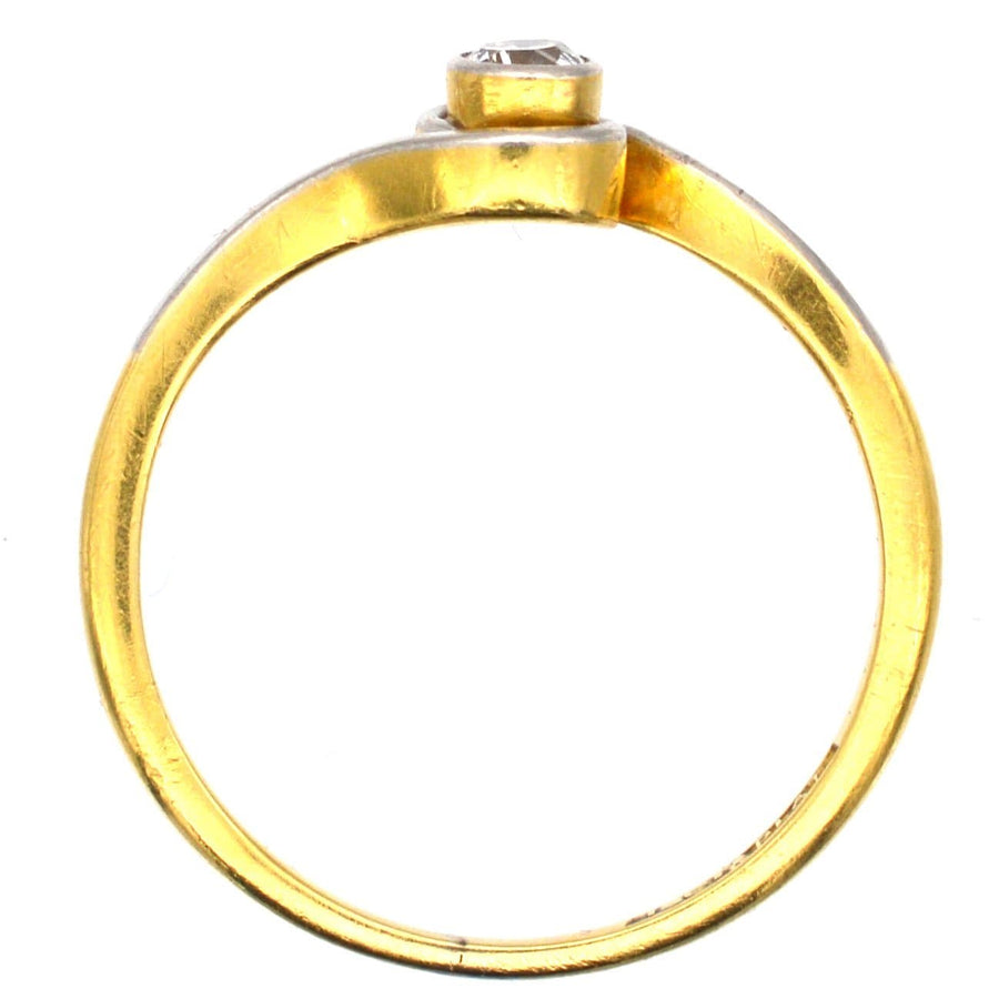 Art Deco 18ct gold and platinum twist solitaire ring with a bezel-set diamond.