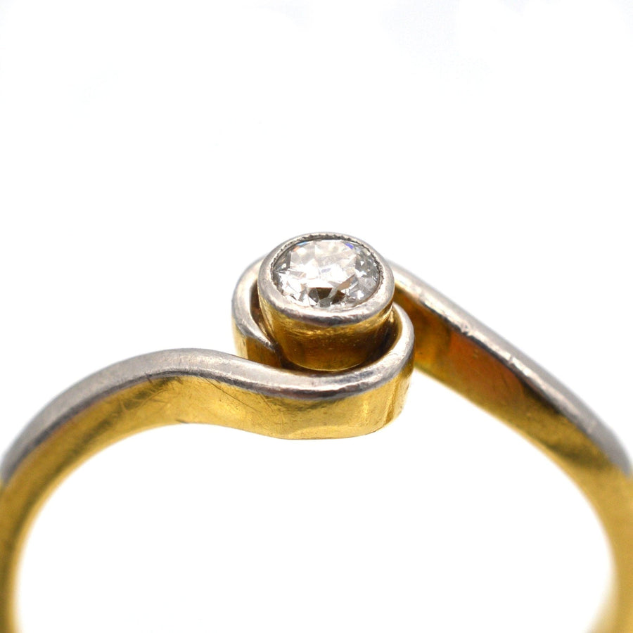Art Deco 18ct gold & platinum twist solitaire ring with a bezel-set diamond, suitable for everyday wear.