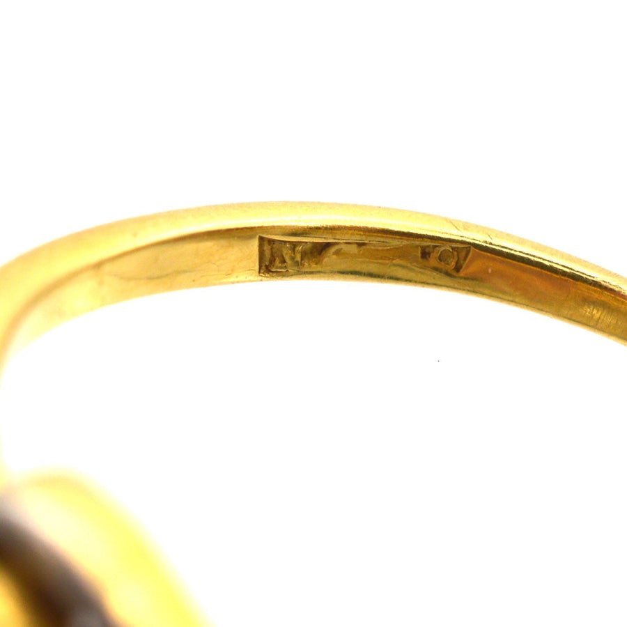 Close-up of the inside band of an Art Deco gold ring showing hallmark and craftsmanship details.