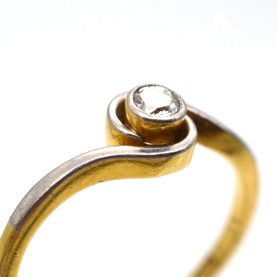 Art Deco 18ct gold and platinum diamond twist solitaire ring with bezel setting, featuring a 0.10 carat diamond.