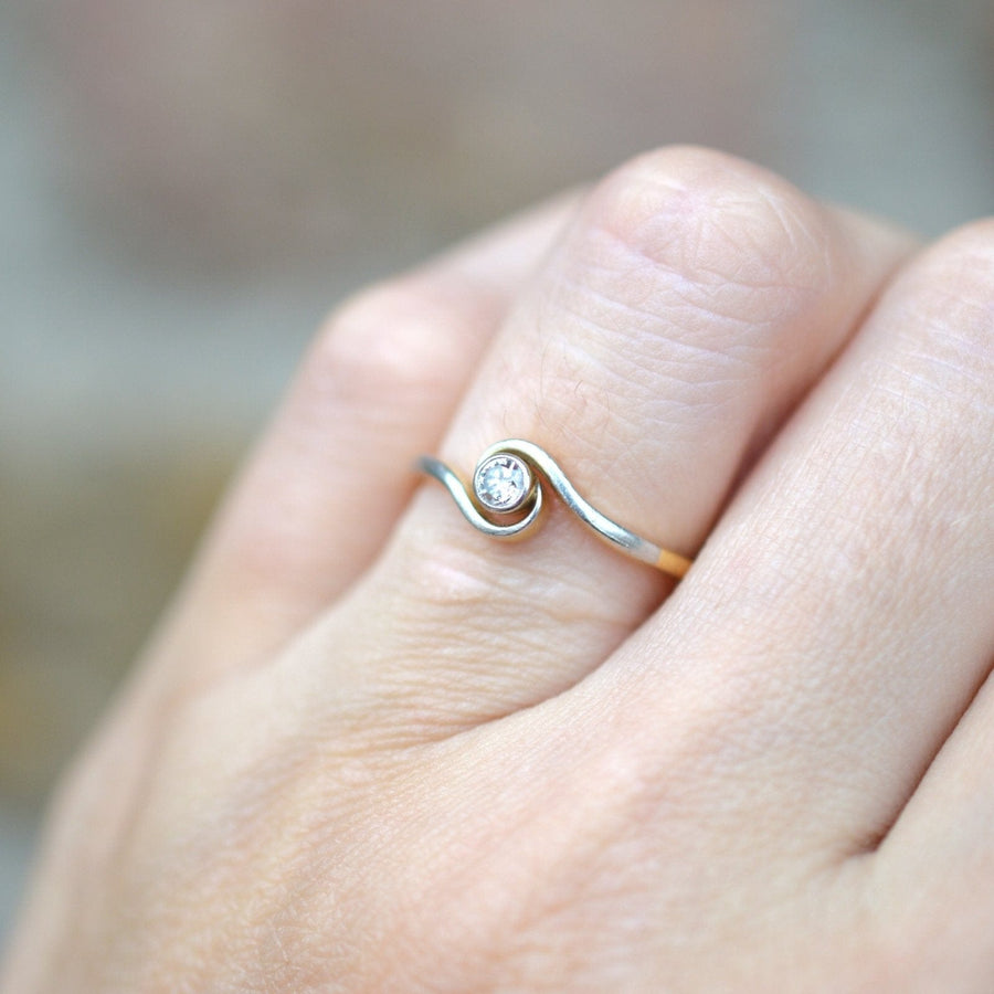 Art Deco 18ct gold and platinum twist solitaire ring with bezel-set diamond, ideal for everyday wear.