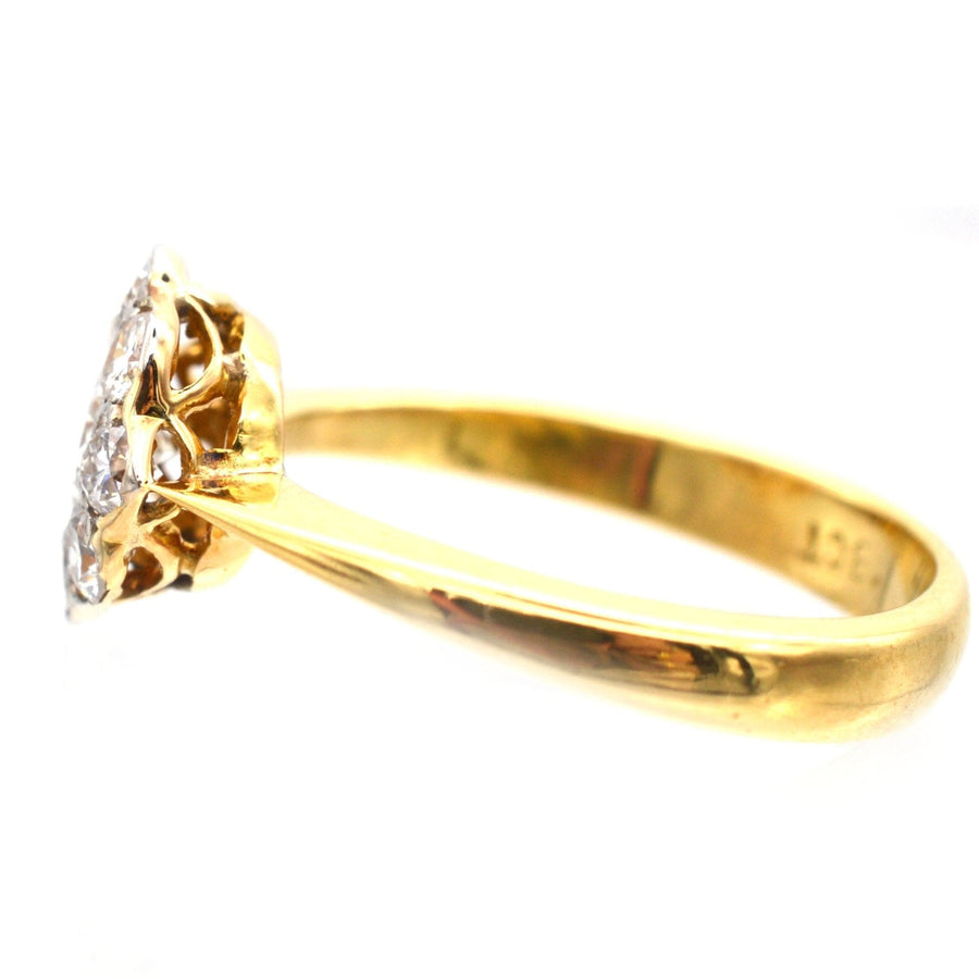 Art Deco 18ct gold and platinum diamond cluster ring, featuring a 0.20ct center diamond and 0.40ct surrounding diamonds.