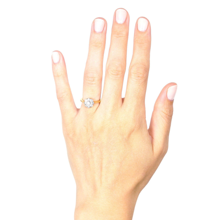 Art Deco 18ct gold and platinum diamond cluster ring worn on a hand, showcasing its elegance.