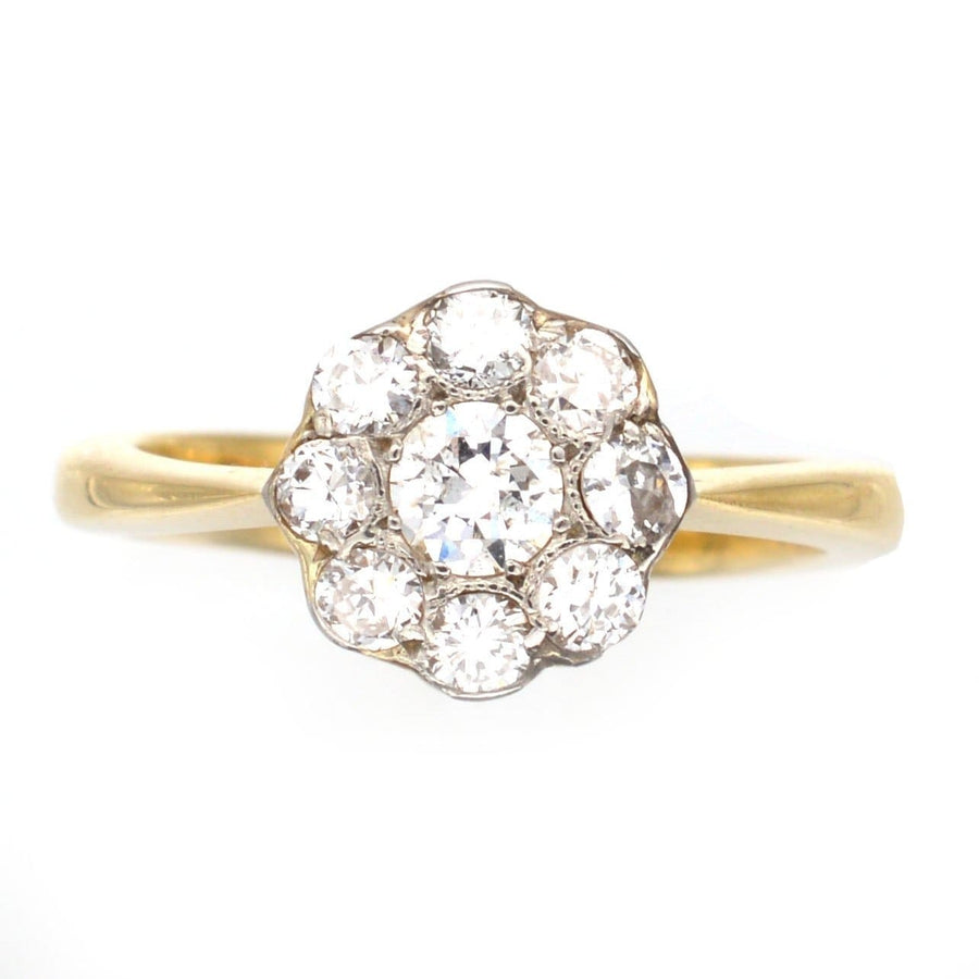 Art Deco diamond cluster ring in 18ct gold and platinum, featuring a central 0.20ct diamond and surrounding diamonds.
