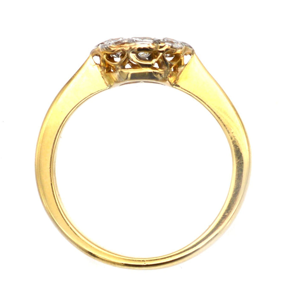 Art Deco 18ct gold and platinum diamond cluster ring, featuring a 0.20ct center diamond and 0.40ct surrounding diamonds.