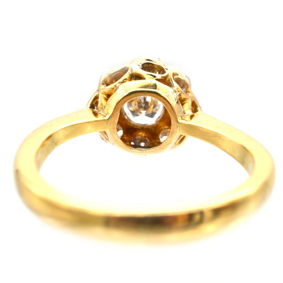 Art Deco 18ct gold and platinum diamond cluster ring from the 1930s, showcasing a central 0.20ct diamond.