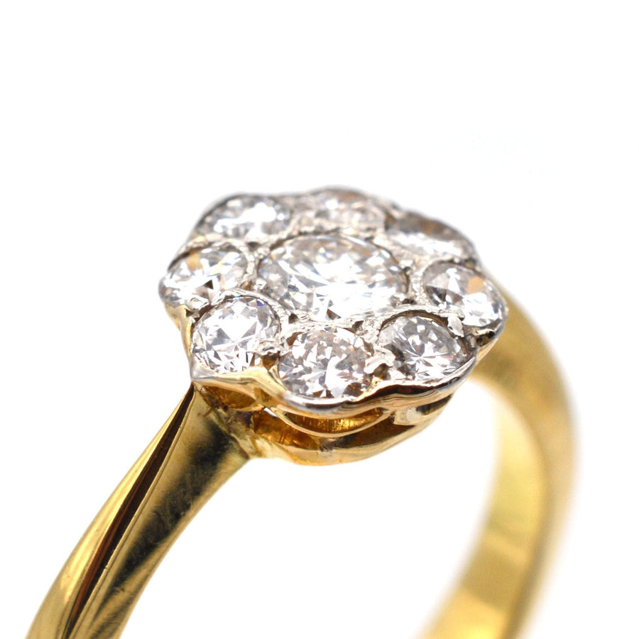 Art Deco 18ct gold and platinum diamond cluster ring from the 1930s, featuring a 0.20ct center diamond and 0.40ct surrounding diamonds.