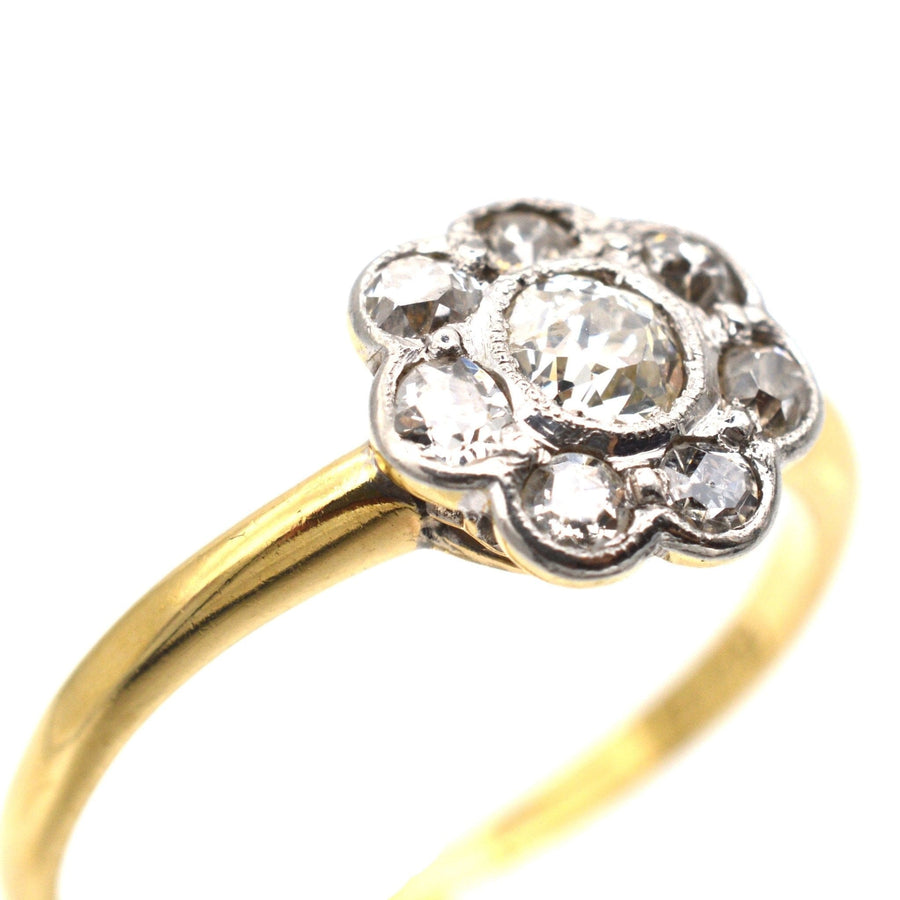 Art Deco diamond cluster ring in 18ct gold and platinum, featuring a 0.20 carat center diamond and 0.35 carats around.