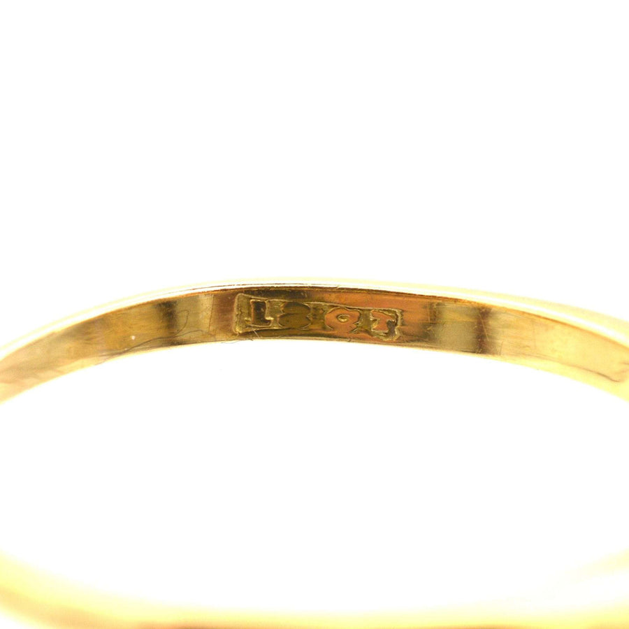Close-up of the hallmark engraving on a piece of 18ct gold jewelry, showing quality and authenticity.