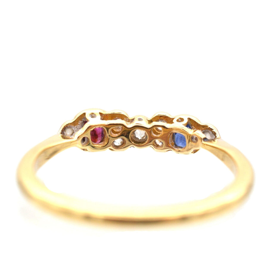 Art Deco 18ct gold and platinum ring featuring oval ruby, sapphire, and sparkling diamonds, perfect for engagement.