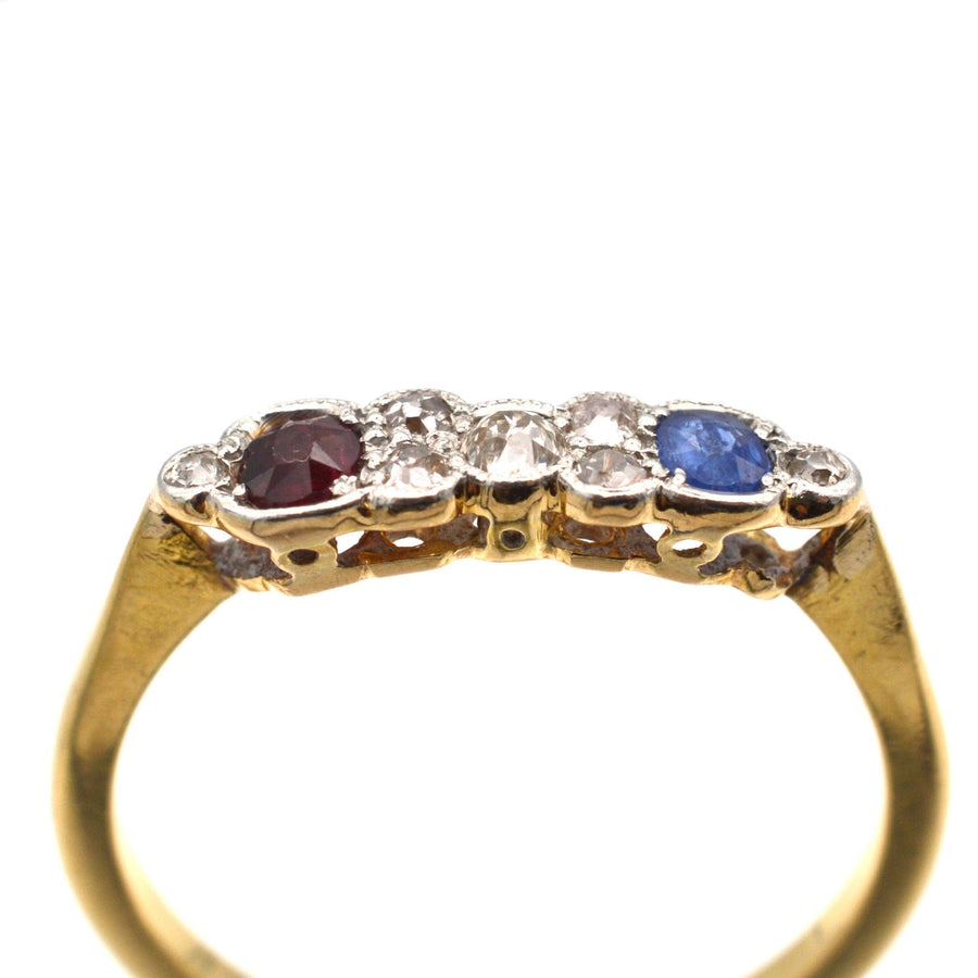 Art Deco gold ring with ruby, sapphire, and sparkling diamonds, perfect for engagement or unique jewelry lover.