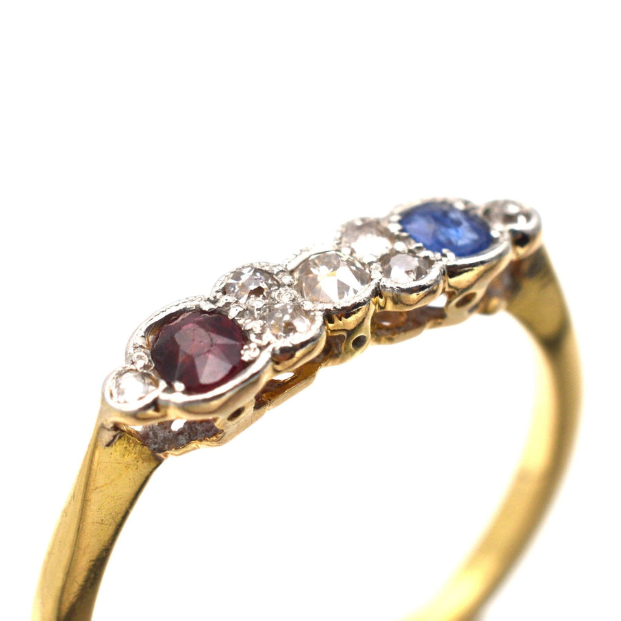 Art Deco 18ct gold and platinum ring featuring oval ruby, sapphire, and sparkling diamonds, ideal for engagements.