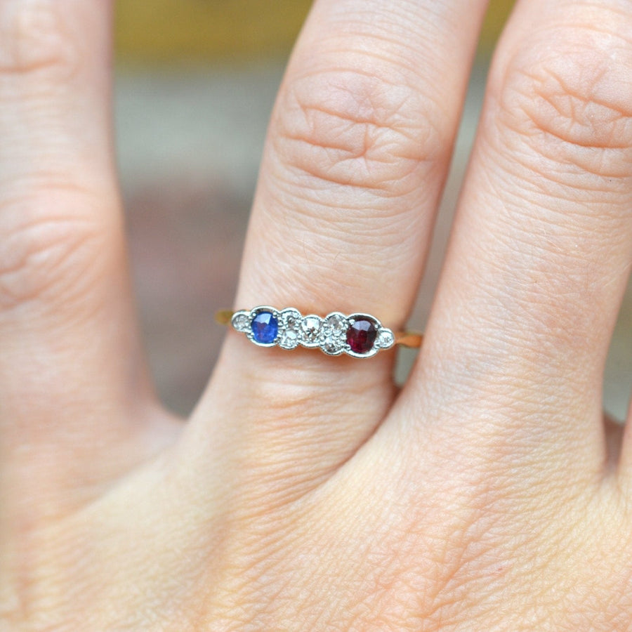 Art Deco 18ct gold ring featuring ruby, sapphire, and diamonds, perfect for an engagement or special occasion.