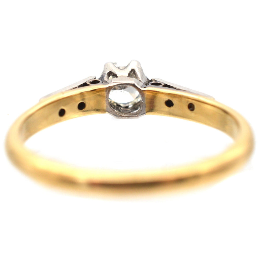 Art Deco 18ct gold and platinum diamond solitaire ring showcasing delicate diamond shoulders, circa 1920s.