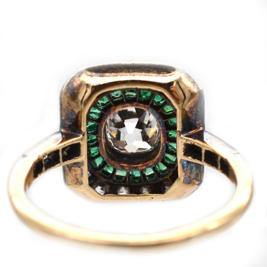 Art Deco 18ct gold and platinum ring featuring an emerald and diamond target design, showcasing an old mine cut diamond.