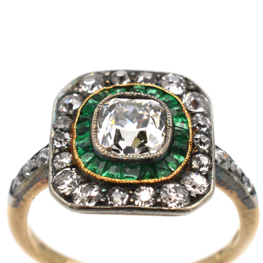 Art Deco 18ct gold and platinum ring featuring an emerald and diamond target design with a large old mine cut diamond.