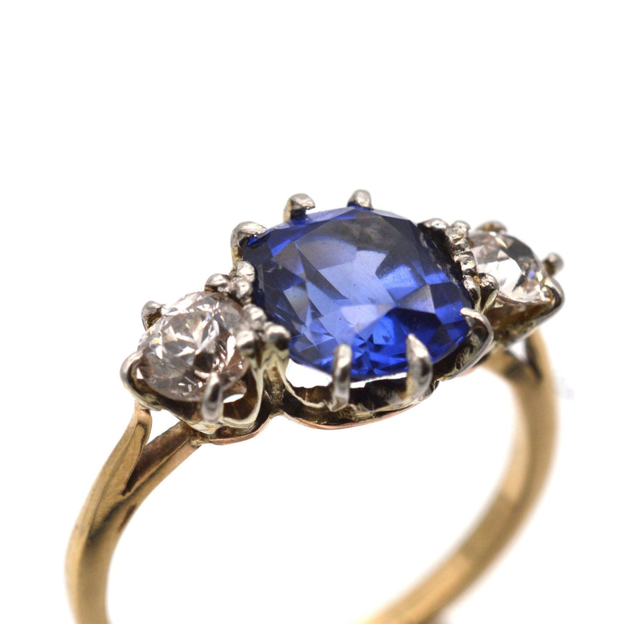 Art Deco 18ct gold ring featuring central sapphire and two diamonds, perfect for engagement or special occasions.