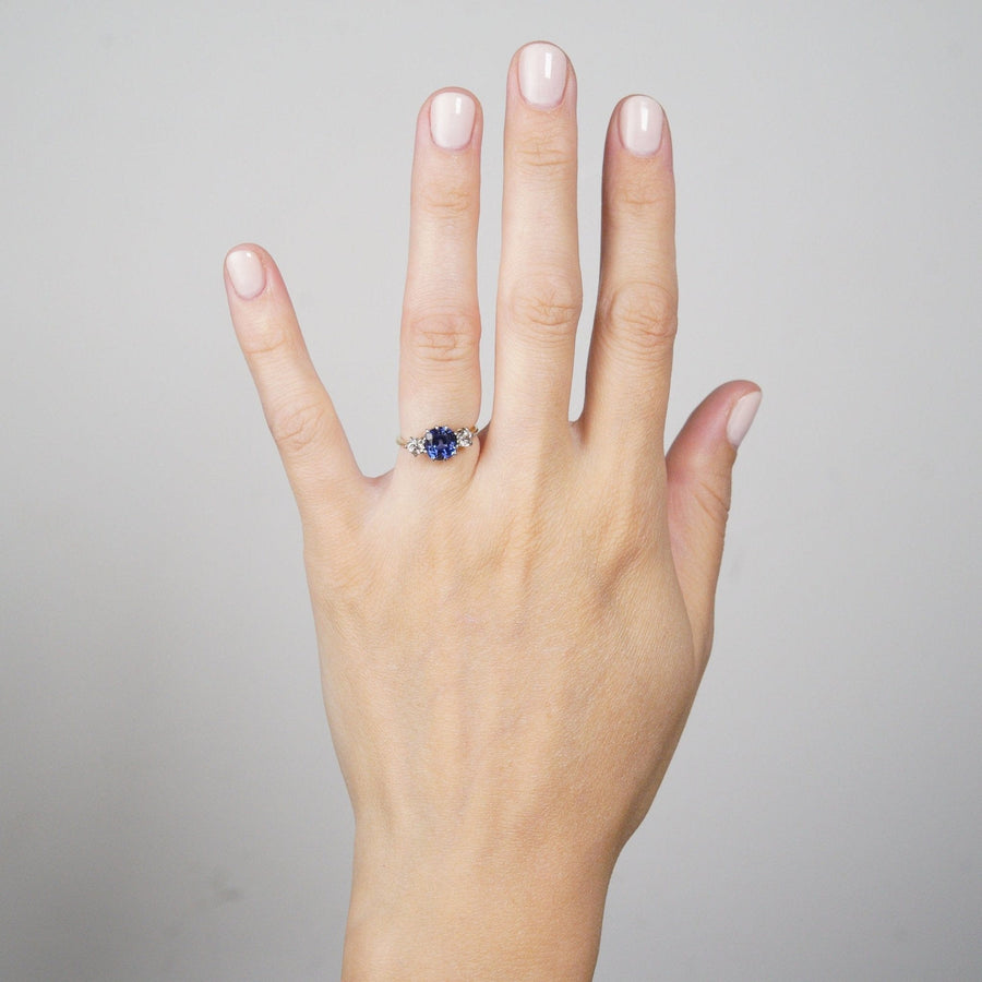 Elegant Art Deco 18ct gold and platinum sapphire and diamond three stone ring worn on a woman's hand.