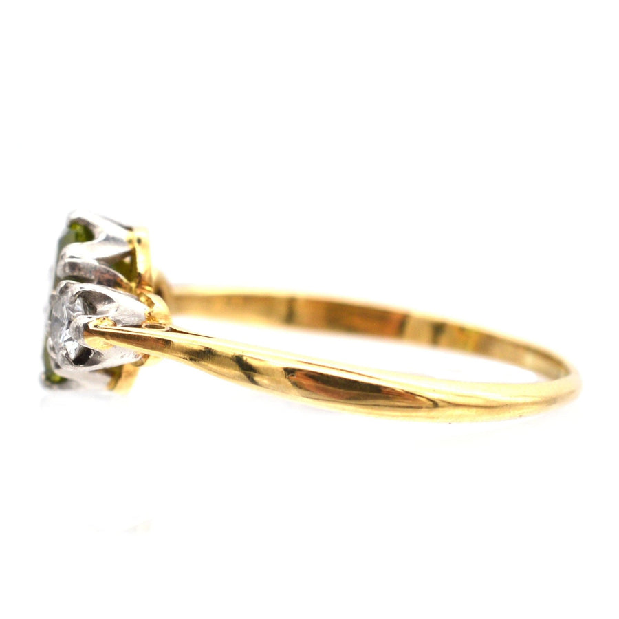Side view of Art Deco 18ct gold and platinum three stone peridot and diamond ring showing olive green peridots.