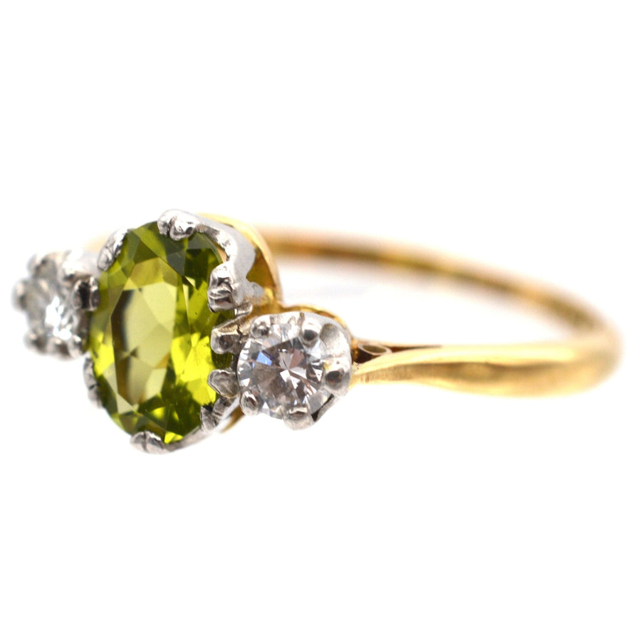 Art Deco 18ct gold and platinum three stone peridot and diamond ring with olive green peridot and sparkling diamonds.