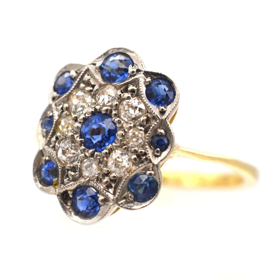 Art Deco 18ct gold ring featuring sapphires and diamonds in a floral cluster design, perfect for engagement.