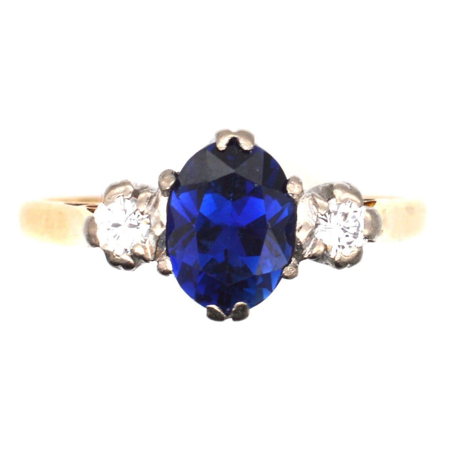 Art Deco 18ct gold ring featuring a large blue sapphire and two sparkling diamonds, ideal for engagement.