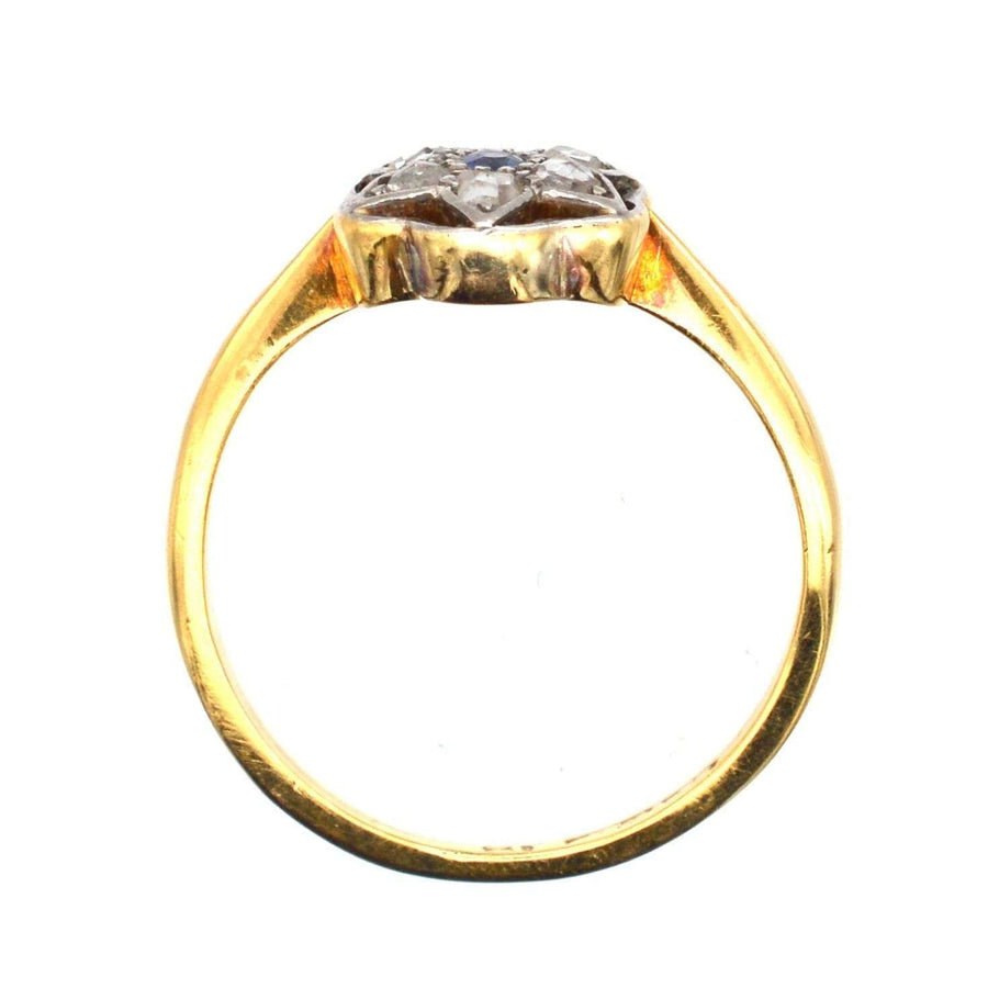 Art Deco gold and platinum ring featuring rose cut diamonds and a sapphire, elegant flower or star design.