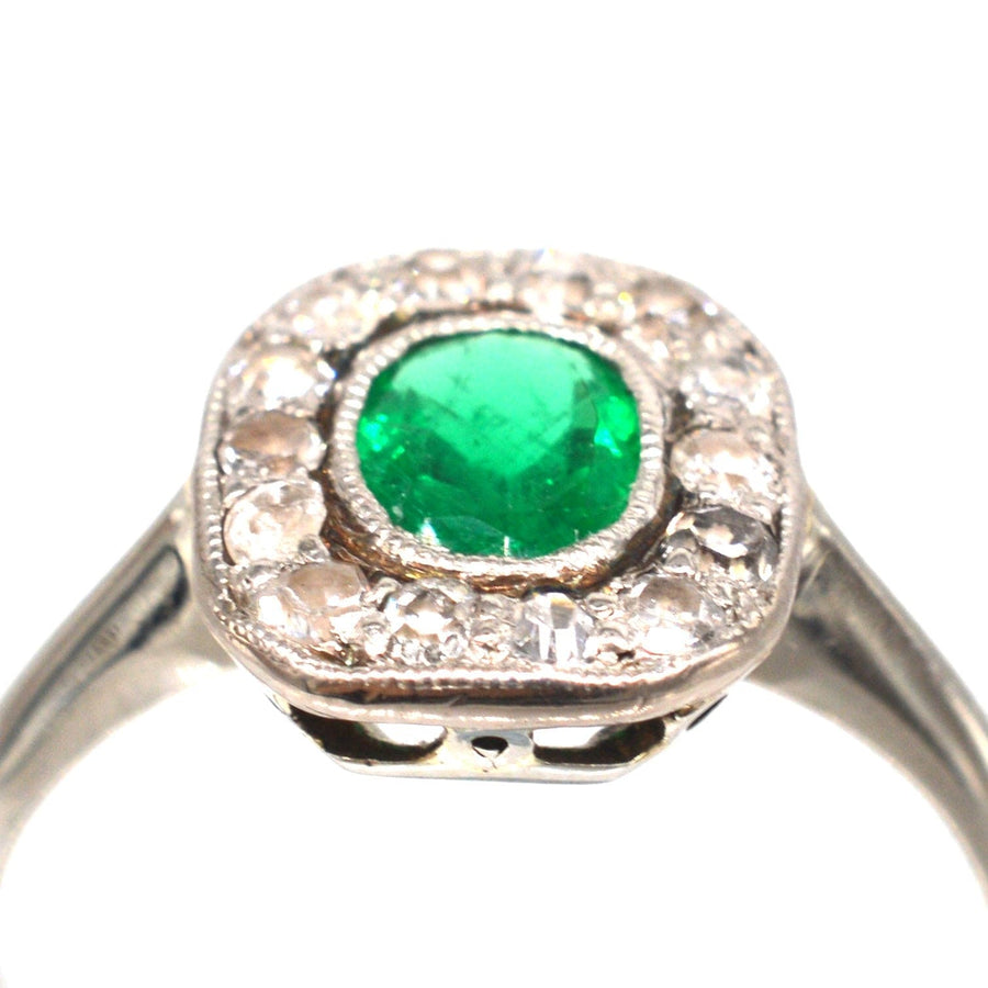 Art Deco 18ct white gold ring featuring a vibrant green emerald and diamond cluster, perfect for an engagement ring.