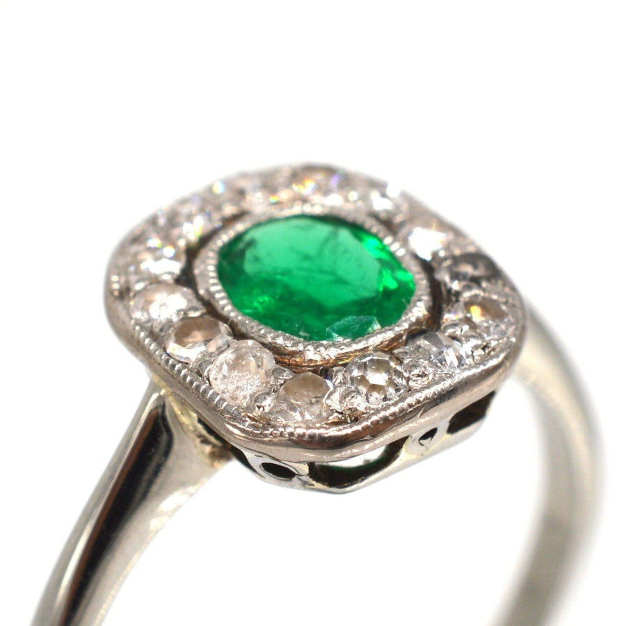 Art Deco 18ct white gold ring featuring a vibrant emerald and sparkling diamond cluster, perfect for engagement.