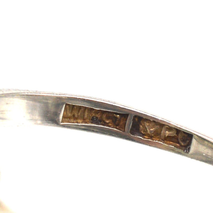 Close-up view of the inner band of an Art Deco ring with hallmarks, showcasing its vintage craftsmanship.