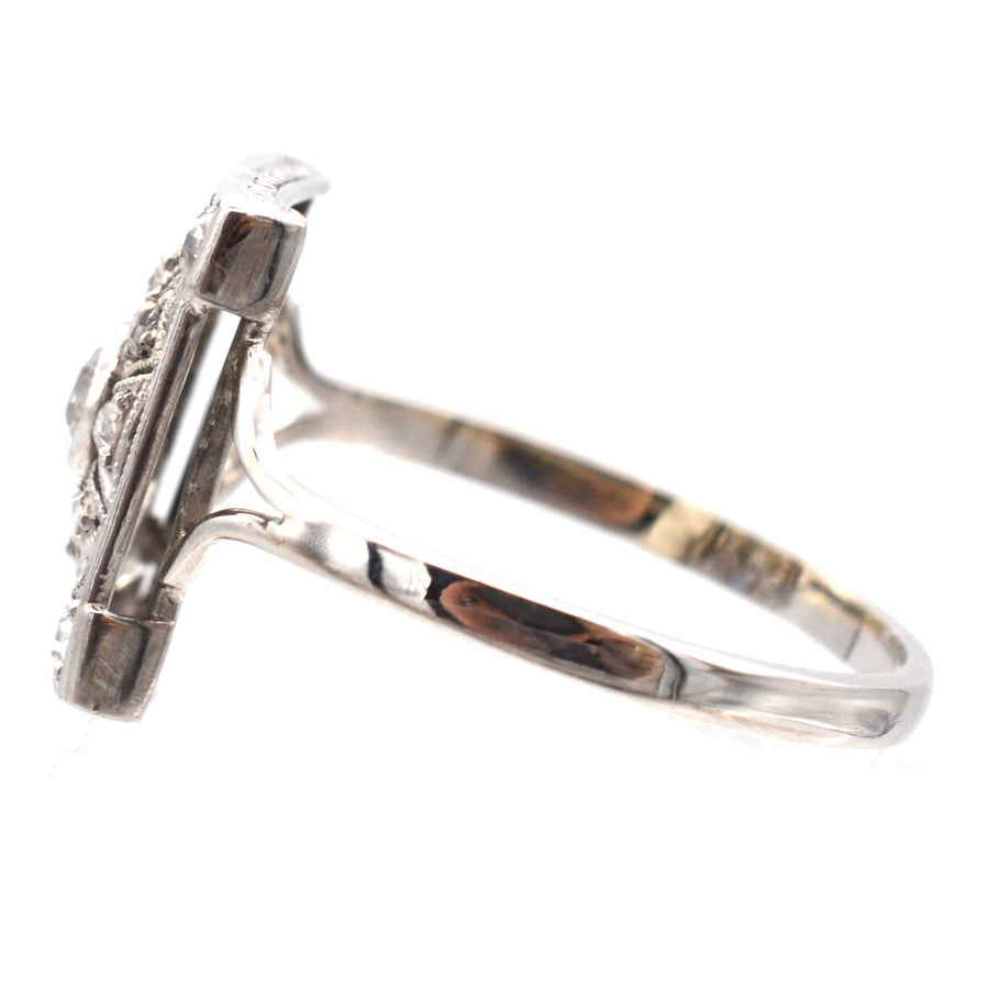 Art Deco 18ct white gold and platinum ring showcasing diamonds and sapphires in a geometrical design.