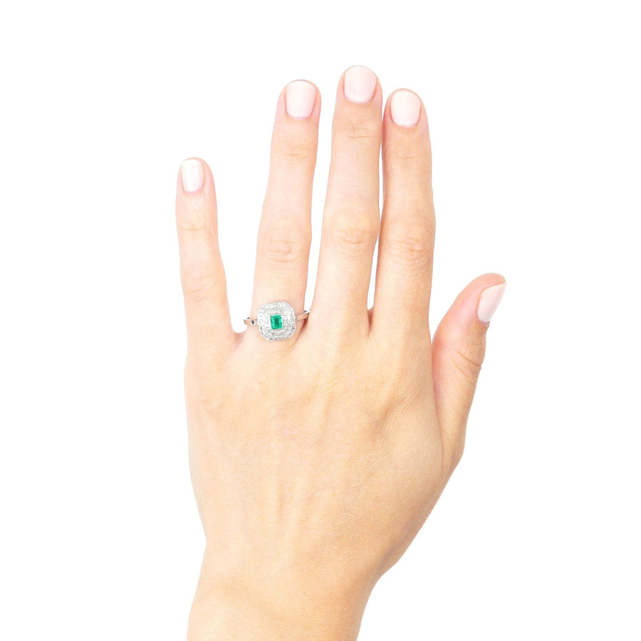Art Deco 18ct white gold and platinum emerald and diamond ring worn on a hand, showcasing its elegance.