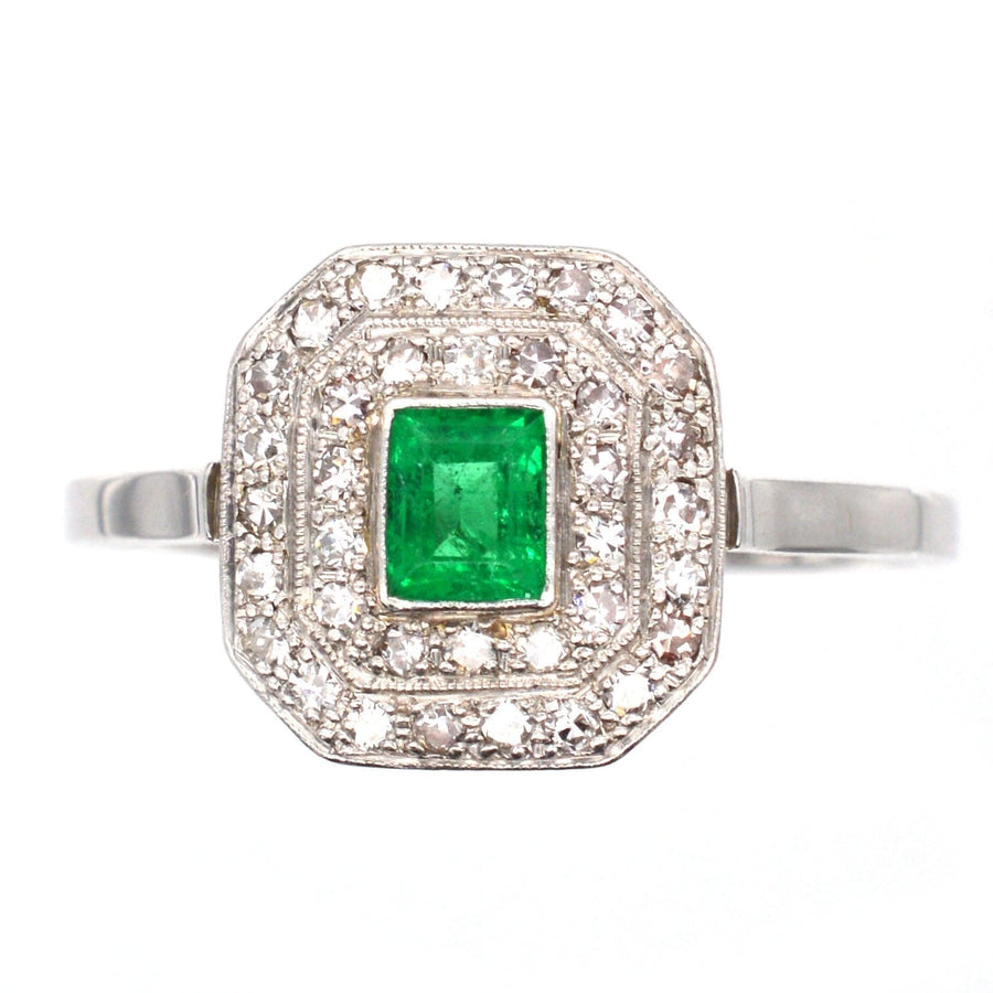 Art Deco 18ct white gold and platinum emerald and diamond ring, vintage cluster design from the 1920s.