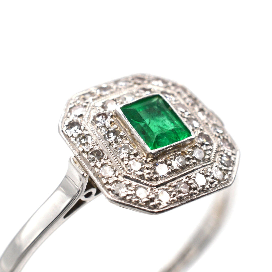 Art Deco 18ct white gold and platinum emerald diamond cluster ring with millegrain set diamonds.