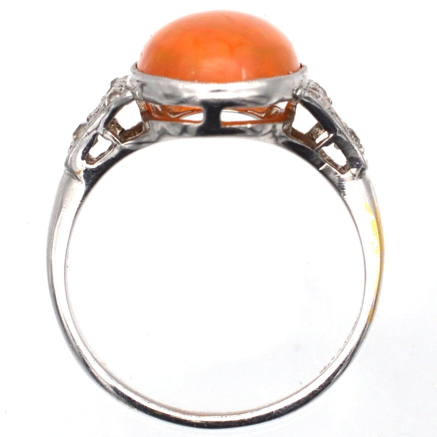 Art Deco 18ct white gold and platinum ring featuring a natural Mexican fire jelly opal and diamond accents.