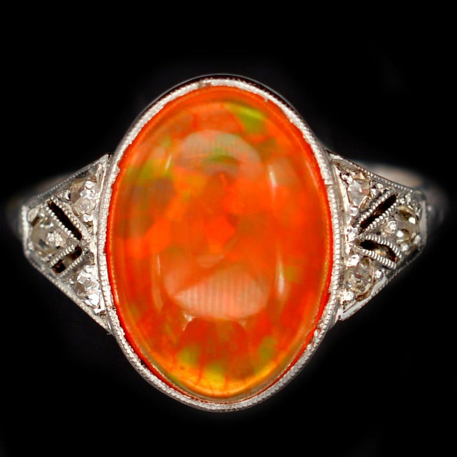 Art Deco 18ct white gold ring with natural Mexican fire jelly opal and diamonds, showcasing vibrant orange hues.