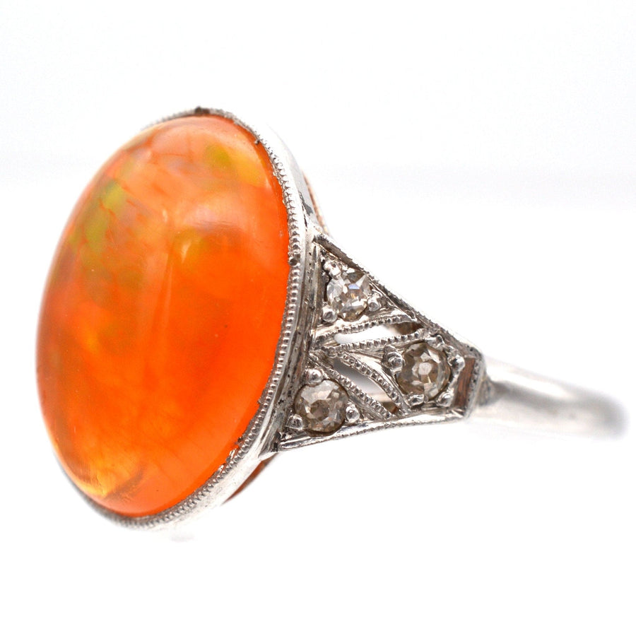Art Deco 18ct white gold and platinum ring featuring a natural Mexican fire jelly opal with diamond accents.