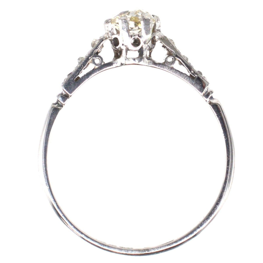 Art Deco 18ct white gold and platinum solitaire ring featuring old mine cut diamond and elegant design.