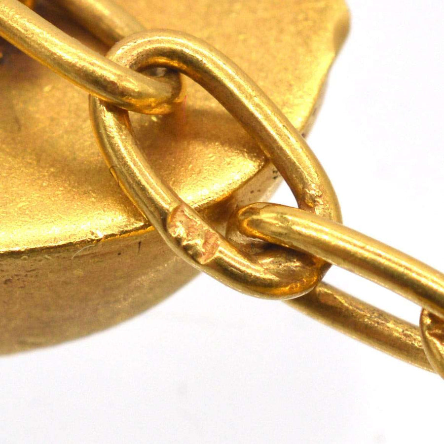 Close-up of Art Deco gold cufflink chain link showing intricate design and craftsmanship.