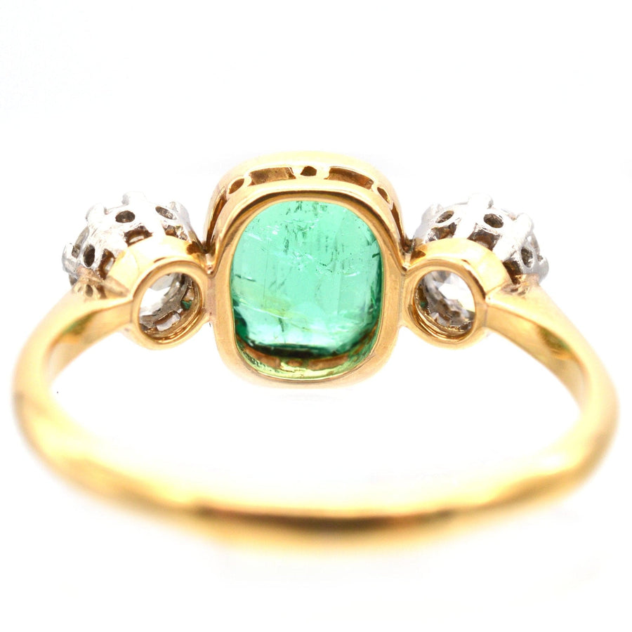 Art Deco emerald and diamond three stone ring in 18ct gold and platinum, perfect for engagements or anniversaries.