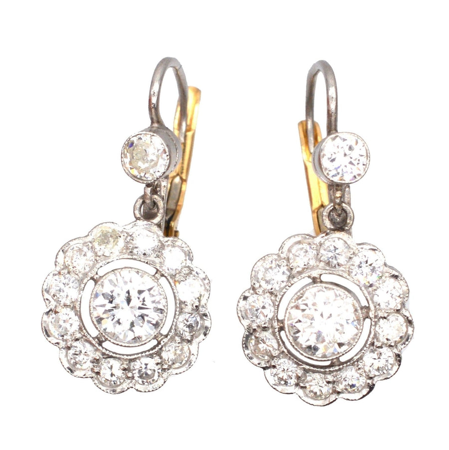 Art Deco platinum and gold diamond cluster drop earrings featuring 1.25 carats of sparkling white diamonds.