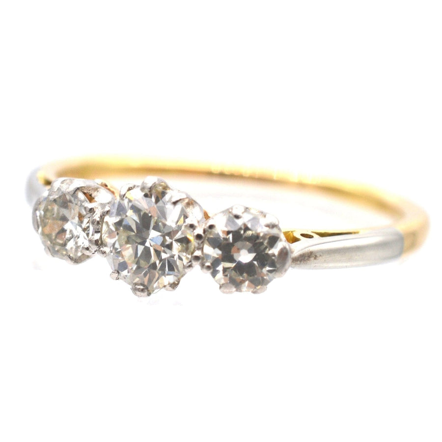 Art Deco platinum and 18ct gold three stone diamond ring, featuring clear and sparkling diamonds, ideal for engagement.