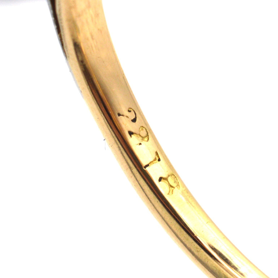Close-up of the inner band of a platinum and gold diamond ring showing hallmark 2718.