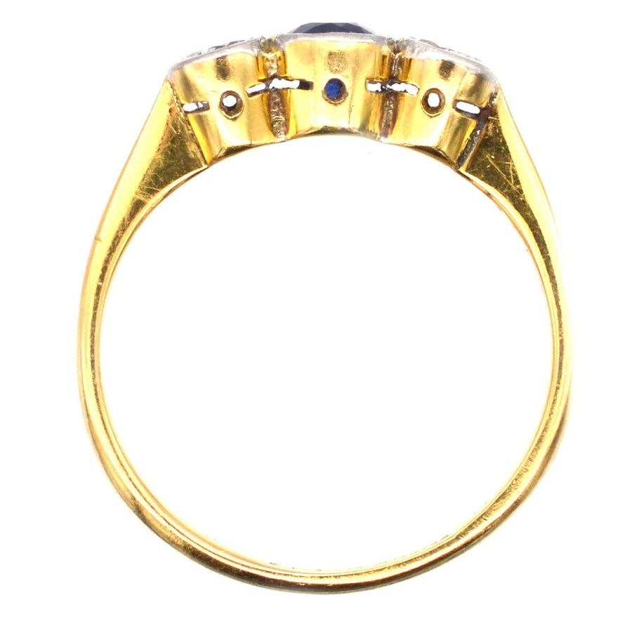 Art Deco three stone sapphire and diamond bezel ring in platinum and 18ct gold, showcasing vibrant Ceylon sapphire.