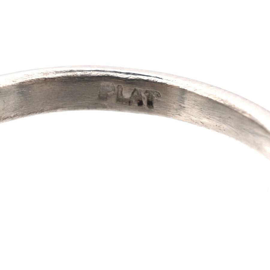 Close-up of the interior engraving of a platinum ring, marked "PLAT" for authenticity.