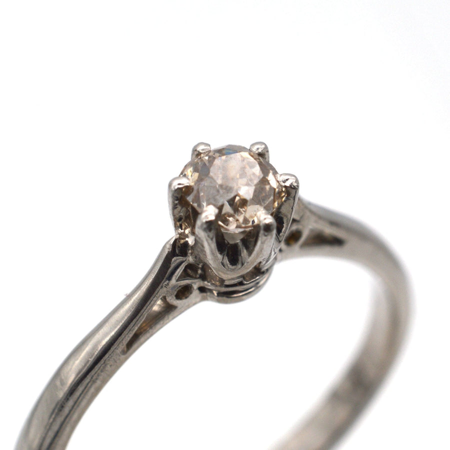 Art Deco platinum ring featuring a cognac diamond solitaire, showcasing vintage elegance and unique character.