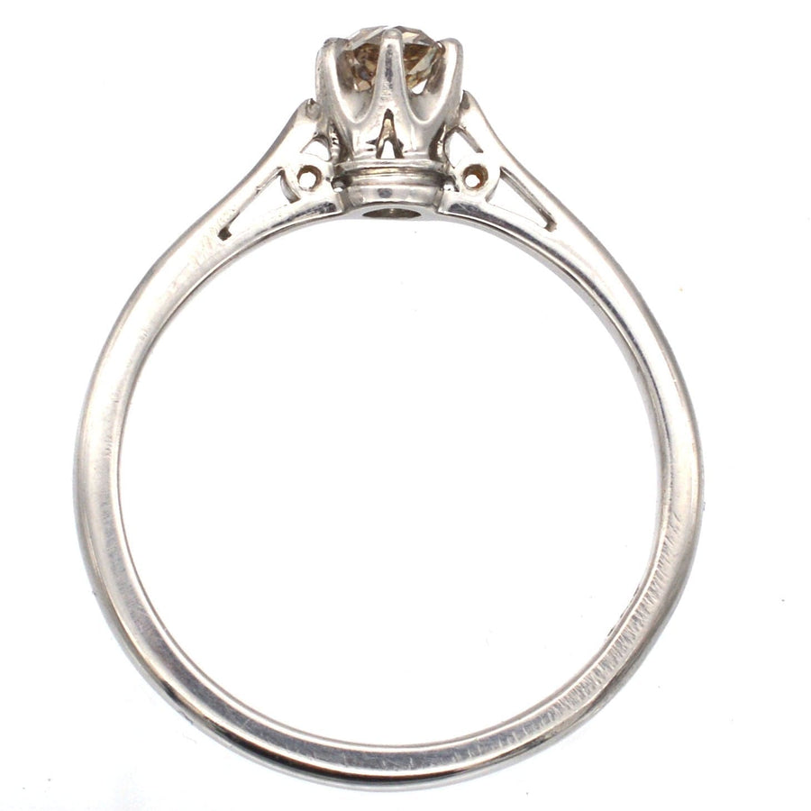 Art Deco platinum solitaire ring featuring an old mine cut Cognac diamond, showcasing vintage elegance and charm.