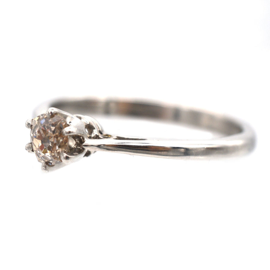 Art Deco platinum solitaire ring featuring a light brown Cognac diamond, perfect for an engagement or special occasion.